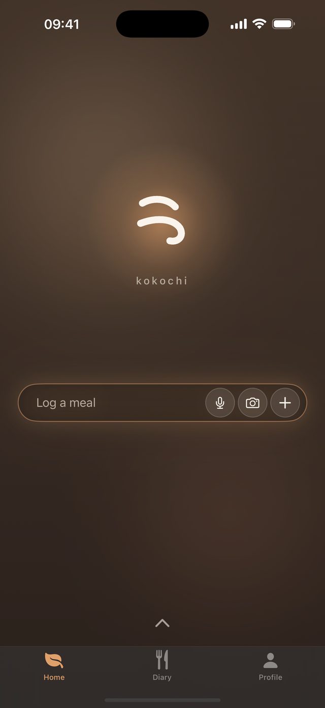 Kokochi home screen: the app’s mark and a single “Log a meal” field with voice, camera and more options